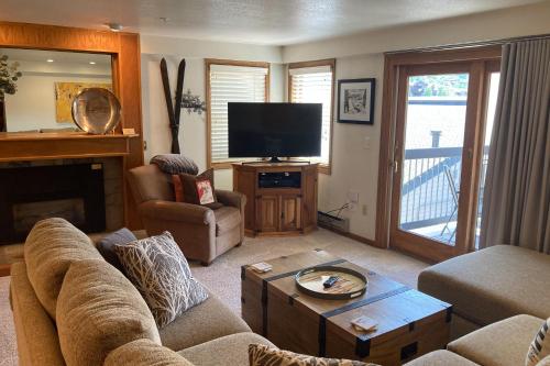 a living room with a couch and a television at Torian Plum Plaza 302 in Steamboat Springs