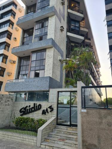 a building with a staircase in front of it at Duplex Beira Mar Pajuçara Maceió in Maceió
