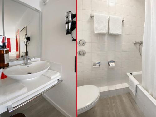 a bathroom with a sink and a toilet and a shower at DORMERO Hotel Hoyerswerda in Hoyerswerda