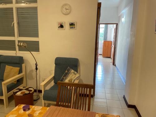 a living room with two chairs and a table at Private Apartment, City Centre, Port Louis in Port Louis