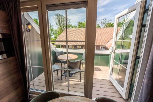 a view of a balcony with a table and chairs at Appartementen De Witte Brugh in Buren