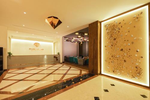 a room with a wall with a picture of bees at Pearl Grand By Rathna in Colombo