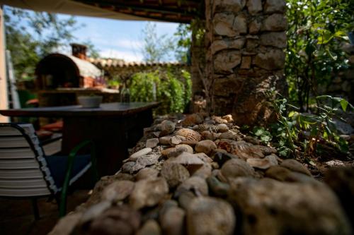 a pile of rocks sitting on a patio at Apartman Silna your new home with terrace and garden in Bobovišća