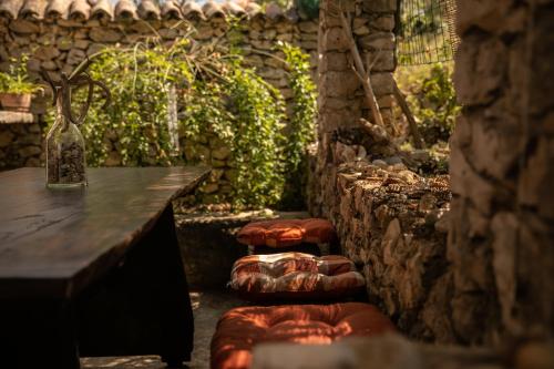 a row of stools next to a table in a room at Apartman Silna your new home with terrace and garden in Bobovišća