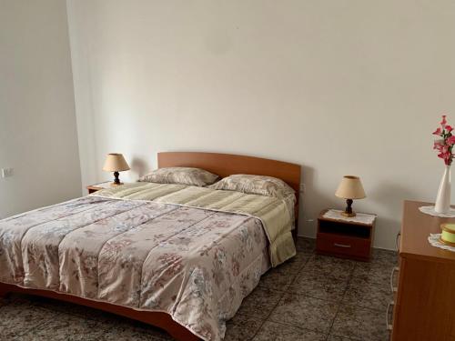 a bedroom with a large bed and two night stands at 2 Bedroom Appartment Birzebbugia in Birżebbuġa