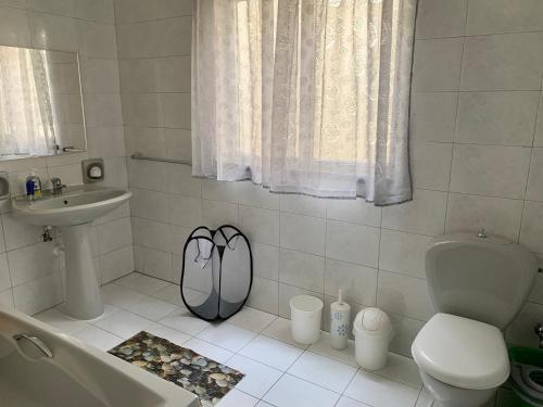 a bathroom with a sink and a toilet and a sink at 2 Bedroom Appartment Birzebbugia in Birżebbuġa