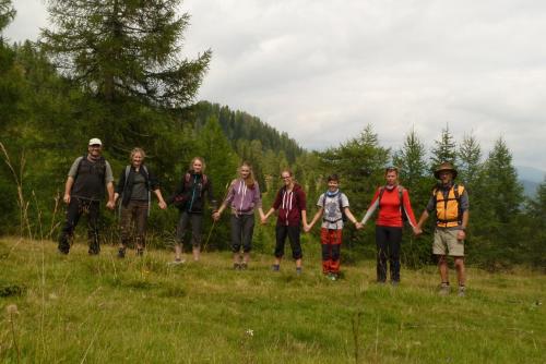 a group of people standing in a field at Almhütte Badstube in Patergassen
