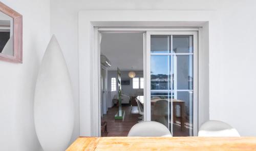 a dining room with a table and a view of a room at Dúplex Playa in San José