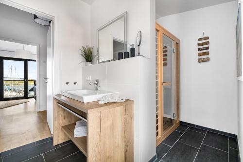 a bathroom with a sink and a mirror at Hafenquartier No5 in Heiligenhafen