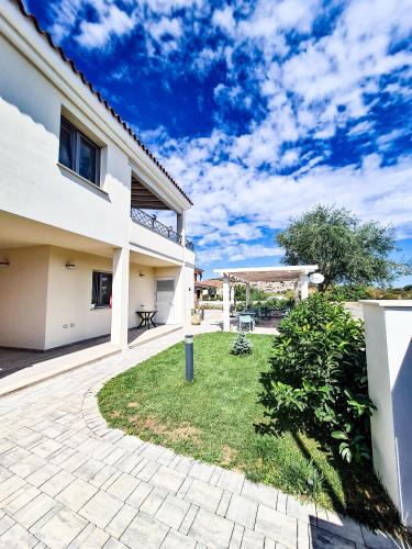 a house with a patio and a yard at Affittacamere Bellavista Posada in Posada