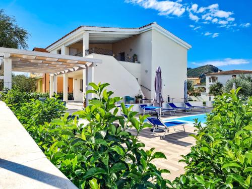 a villa with a swimming pool and a house at Affittacamere Bellavista Posada in Posada
