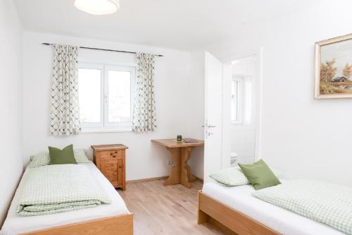a bedroom with two beds and a window at Zum Hirsch in Riefensberg