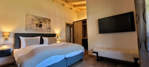 Hochalmbahnen Chalets Rauris 1-19, Maislaufeldweg 1s في راوريس: غرفة نوم مع سرير كبير وتلفزيون بشاشة مسطحة