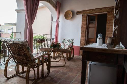 a room with chairs and a table and a balcony at B&B Casa Licheri in San Vito
