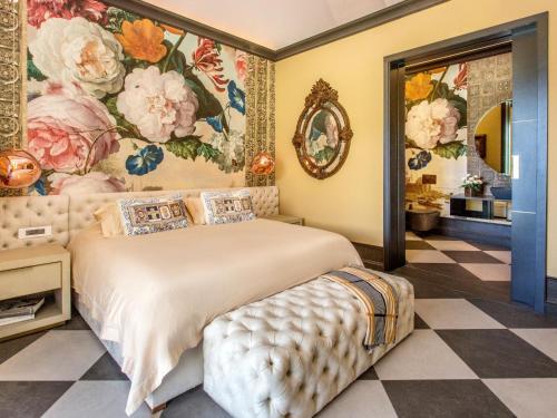 a bedroom with a large bed with a floral wallpaper at Monument House in Franschhoek