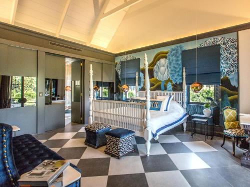 a bedroom with a bed and a checkered floor at Monument House in Franschhoek