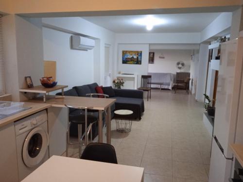 a kitchen and living room with a couch and a table at Nicosia rest and relax 1 bedroom apartment in Nicosia