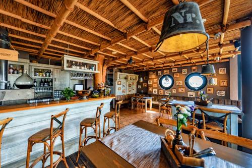 un restaurante con un bar con mesa y sillas en Pension Café Knatter en Ueckeritz