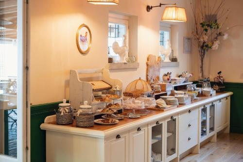 a counter with dishes and other items on it at Guadalupe Tuscany Resort in Braccagni