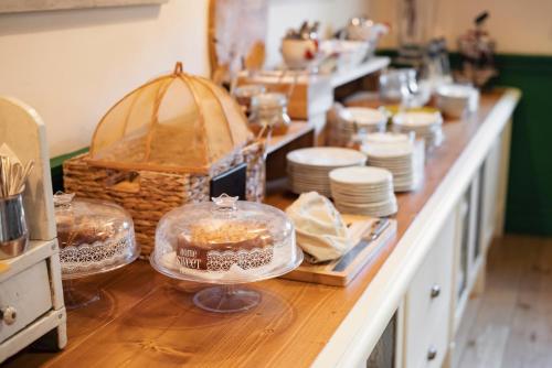 a kitchen counter with plates and dishes on it at Guadalupe Tuscany Resort in Braccagni