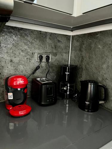 a kitchen counter with a toaster and a coffee maker at Le relais d'Eugènie en hyper centre-ville in Compiègne