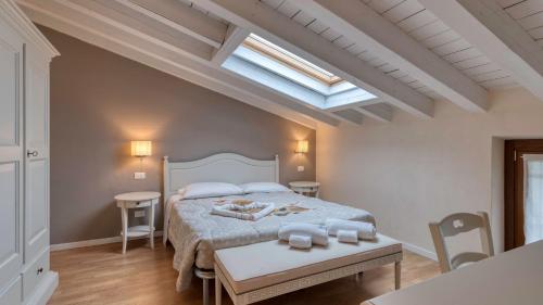 a bedroom with a large bed and a skylight at Cascina Volta in Brescia
