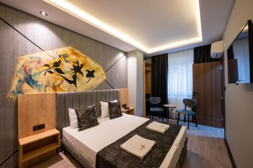 a hotel room with a bed and a painting on the wall at Comfort Point in Istanbul