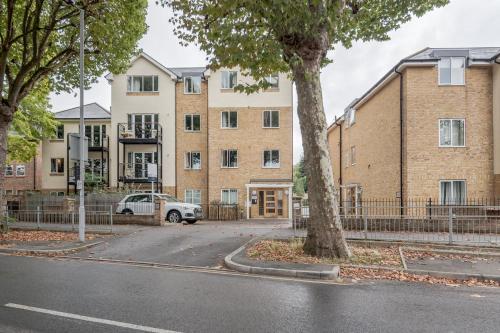 an apartment building with a car parked in front of it at Roomspace Serviced Apartments - Nevis Court in Surbiton