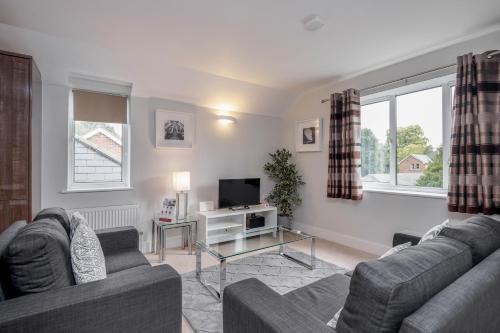 a living room with two couches and a tv at Roomspace Serviced Apartments - Nevis Court in Surbiton