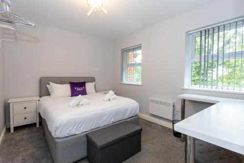 a small bedroom with a bed and a window at Pillo Rooms Serviced Apartments - Trafford in Manchester