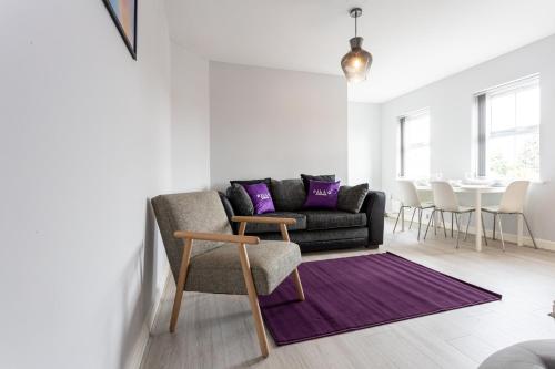 a living room with a couch and a table at Pillo Rooms Serviced Apartments - Trafford in Manchester