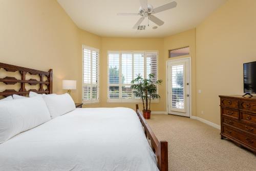a bedroom with a large bed and a ceiling fan at Casa Highland home in Fountain Hills