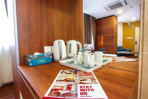 a hotel room with a desk with a magazine at CitiVilla Penang in George Town