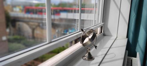 a pair of glasses sitting on a window sill at Location Location Location, Whole apartment for you! in London