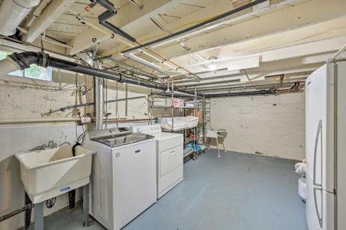 a kitchen with a sink and a washing machine at Stunning Queen Anne House with Private Patio! in Seattle