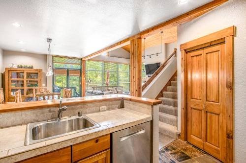 a kitchen with a sink and a staircase at Alpine Holidays Ski Tip in Keystone