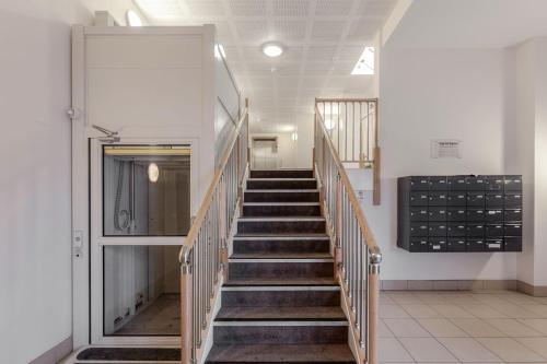 a stairway in a building with a stair case at Roomspace Serviced Apartments - Capitol Square in Epsom