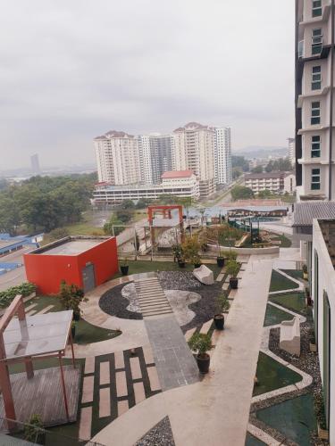 a view of a park with benches and buildings at De Centrum By Jom La Homestay, Kajang Bangi in Kajang