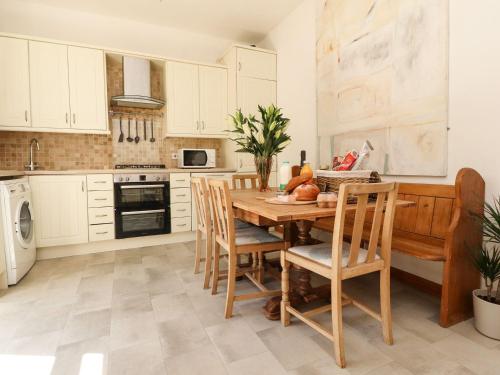 a kitchen with a wooden table and chairs at Number 61 Skipton in Skipton