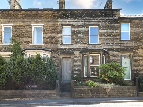 a brick house with a front door and a porch at Number 61 Skipton in Skipton