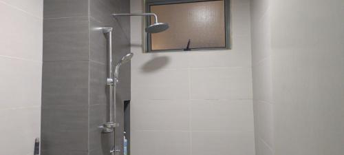 a shower in a bathroom with a mirror at Peace home cybersqure 2 in Cyberjaya