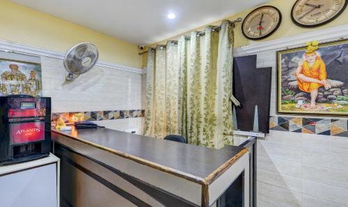 a bar in a room with a clock on the wall at HOTEL SAl INN - NEAR AIRPORT in Chennai