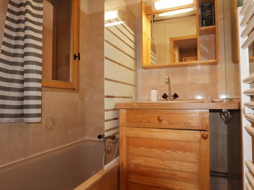 a bathroom with a tub and a sink and a mirror at Studio Morillon Village, 1 pièce, 4 personnes - FR-1-624-60 in Morillon
