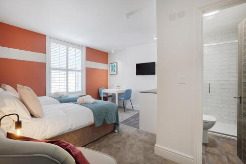 a bedroom with a large bed and a bathroom at Stylish Eco Aparthotel in Folkestone in Folkestone