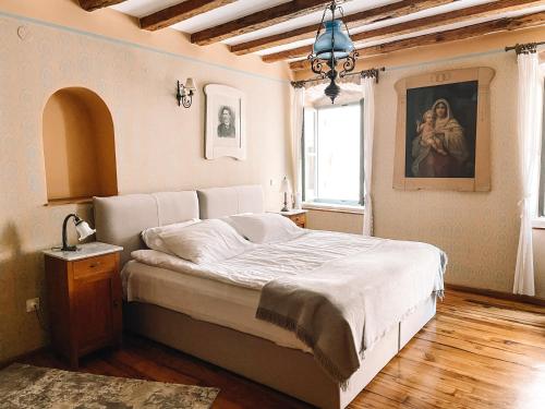 a bedroom with a bed and a painting on the wall at Hotel Casa Garzotto in Rovinj