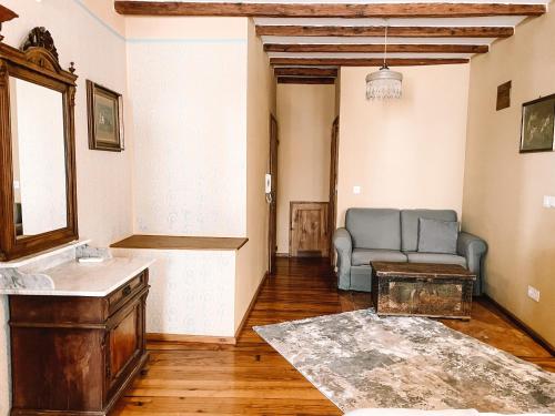 a bathroom with a sink and a couch in a room at Hotel Casa Garzotto in Rovinj