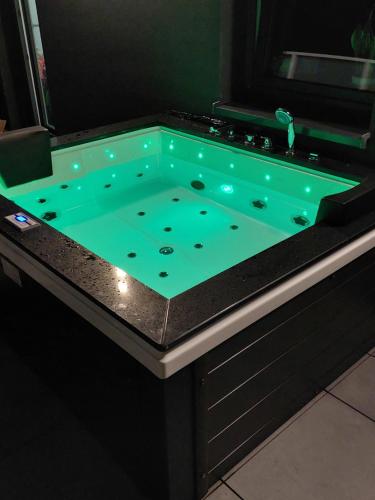 a pool table with a green liquid in it at Sunset Apartament in Wrocław