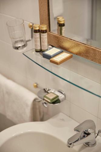 a bathroom with a sink and a mirror and a sink at Hotel Orsaria in Venice