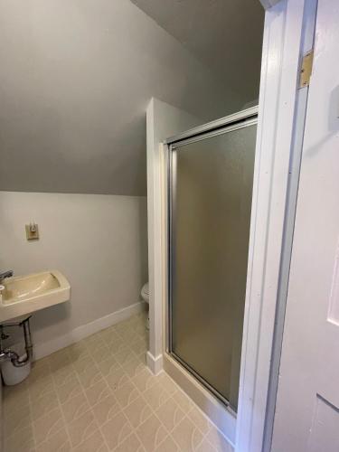 a bathroom with a shower and a sink at Stone Hearth Inn and Eatery in Chester