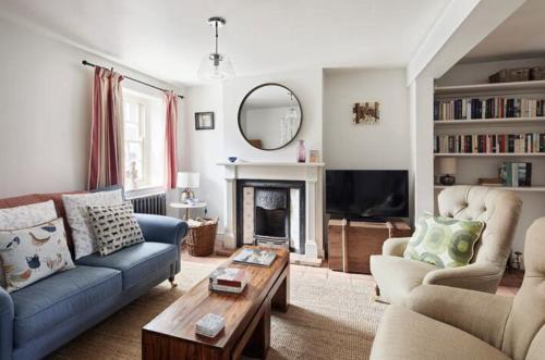 a living room with two couches and a fireplace at Parva House (Holt) in Holt